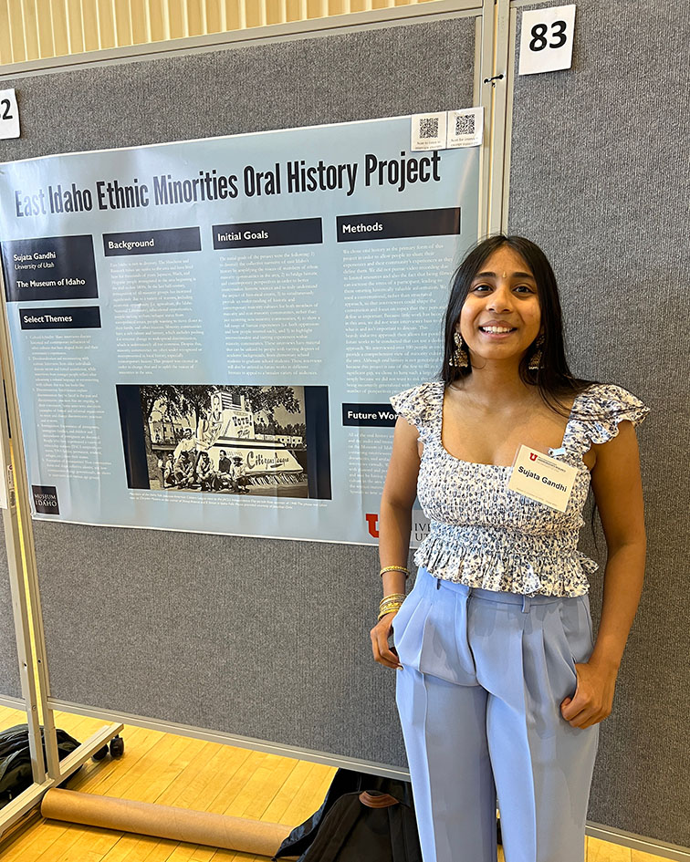 Sujata Gandhi standing in front of their researcg poster