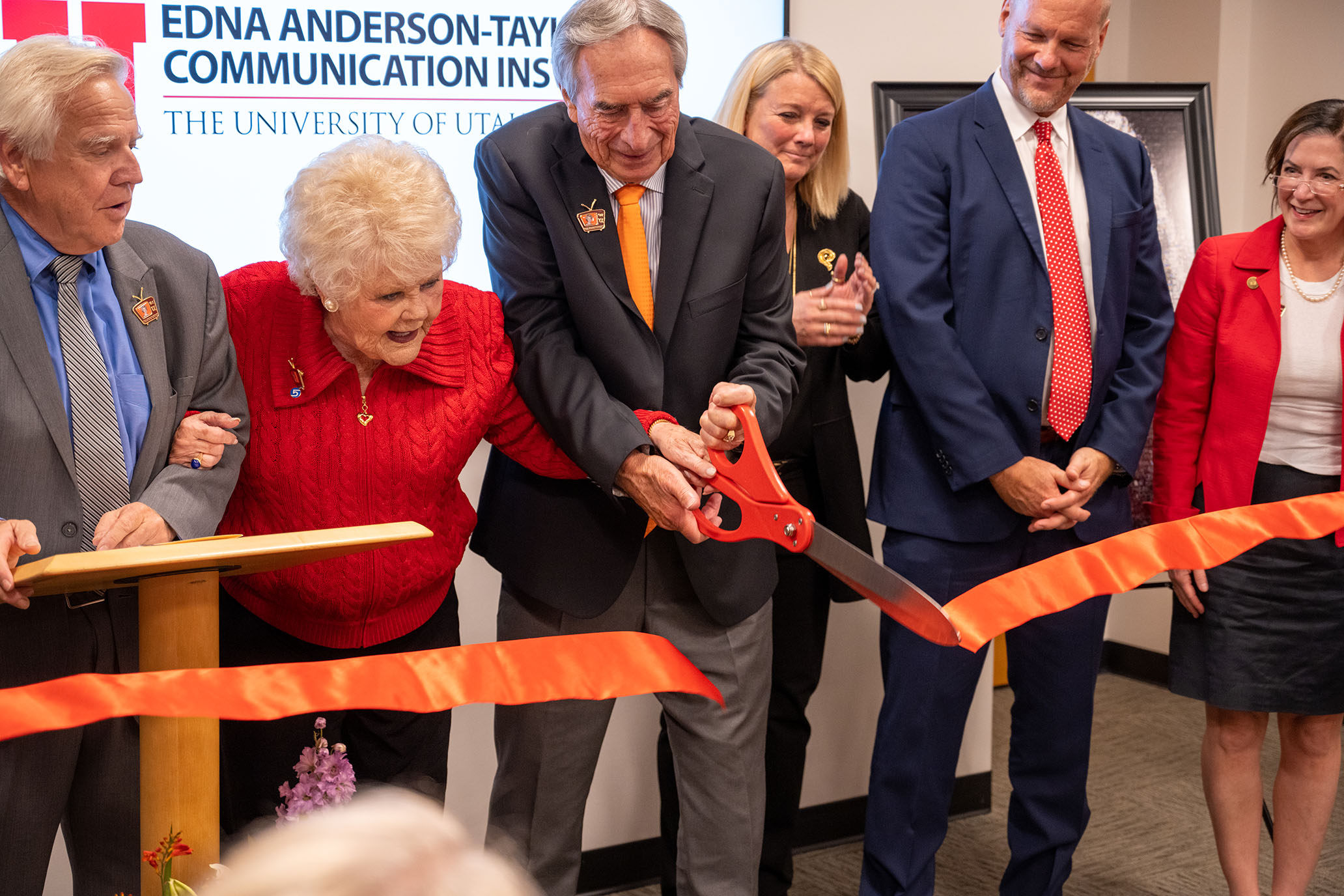 Edna Anderson-Taylor cutting the ribbon for the comm institute.