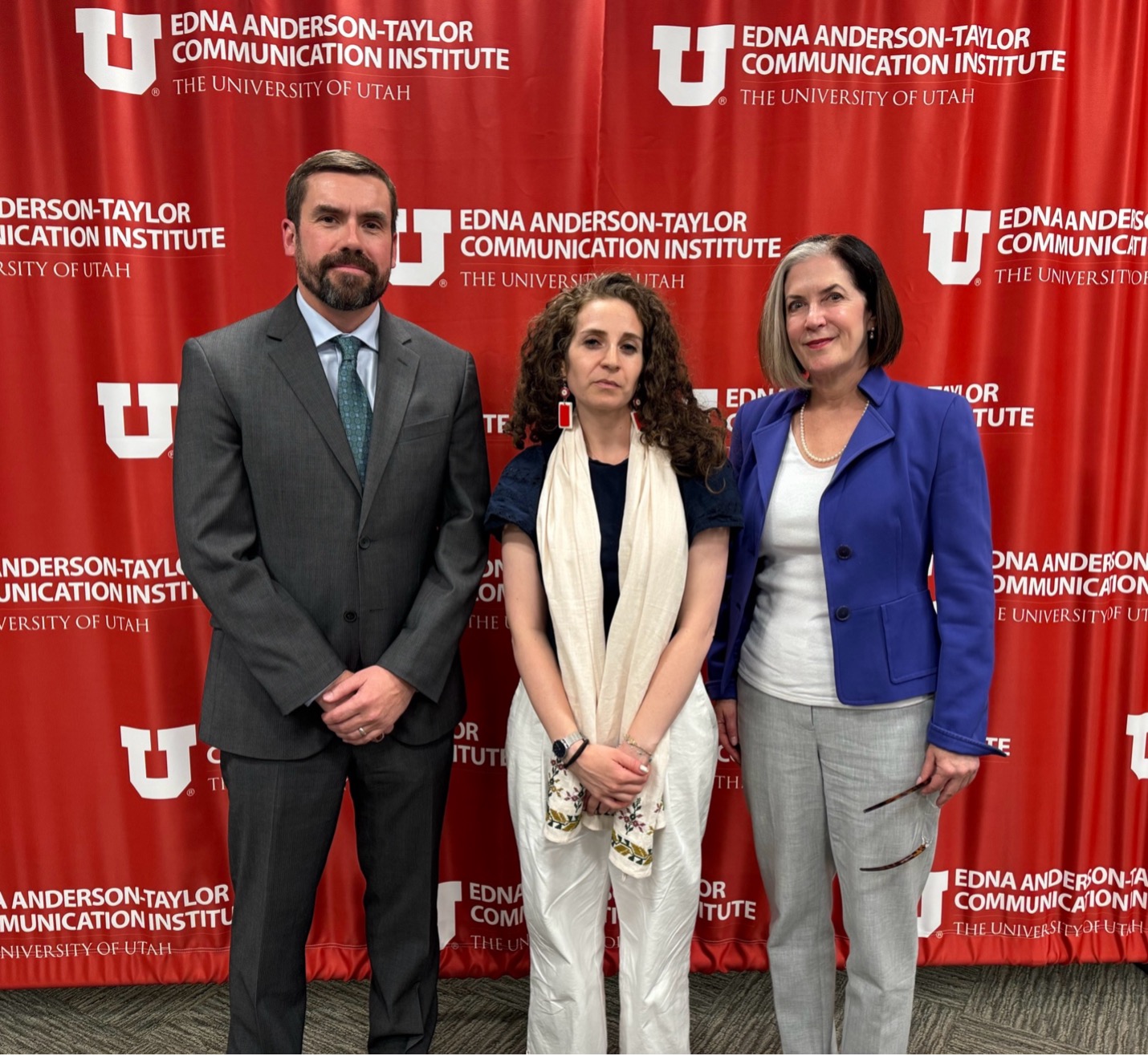 Group of people in front of red background