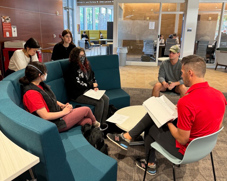 Students sitting around a career coach in the Humanities Hub