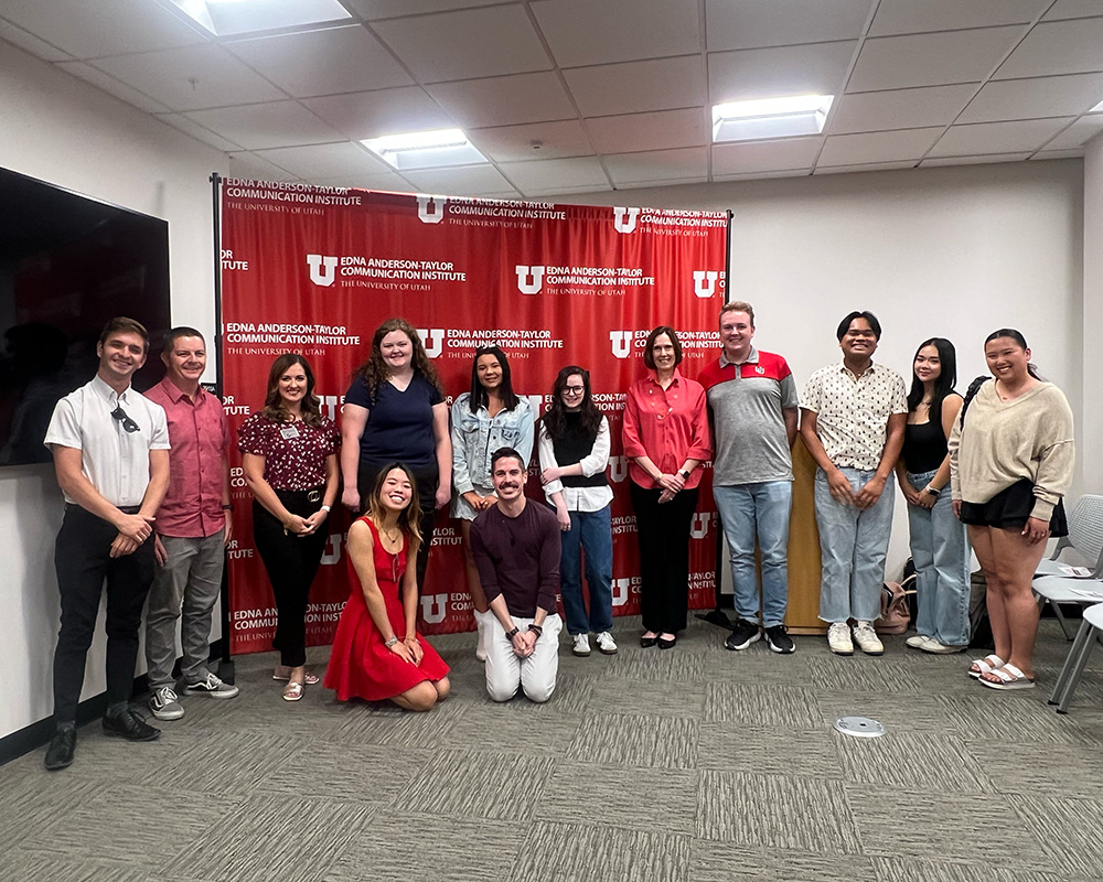 Students and Gray Media representatives standing in front of red backdrop