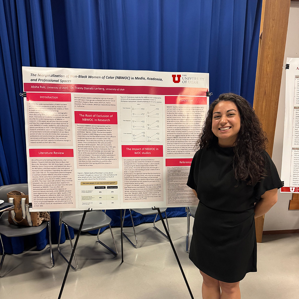 Alisha standing with her research poster 