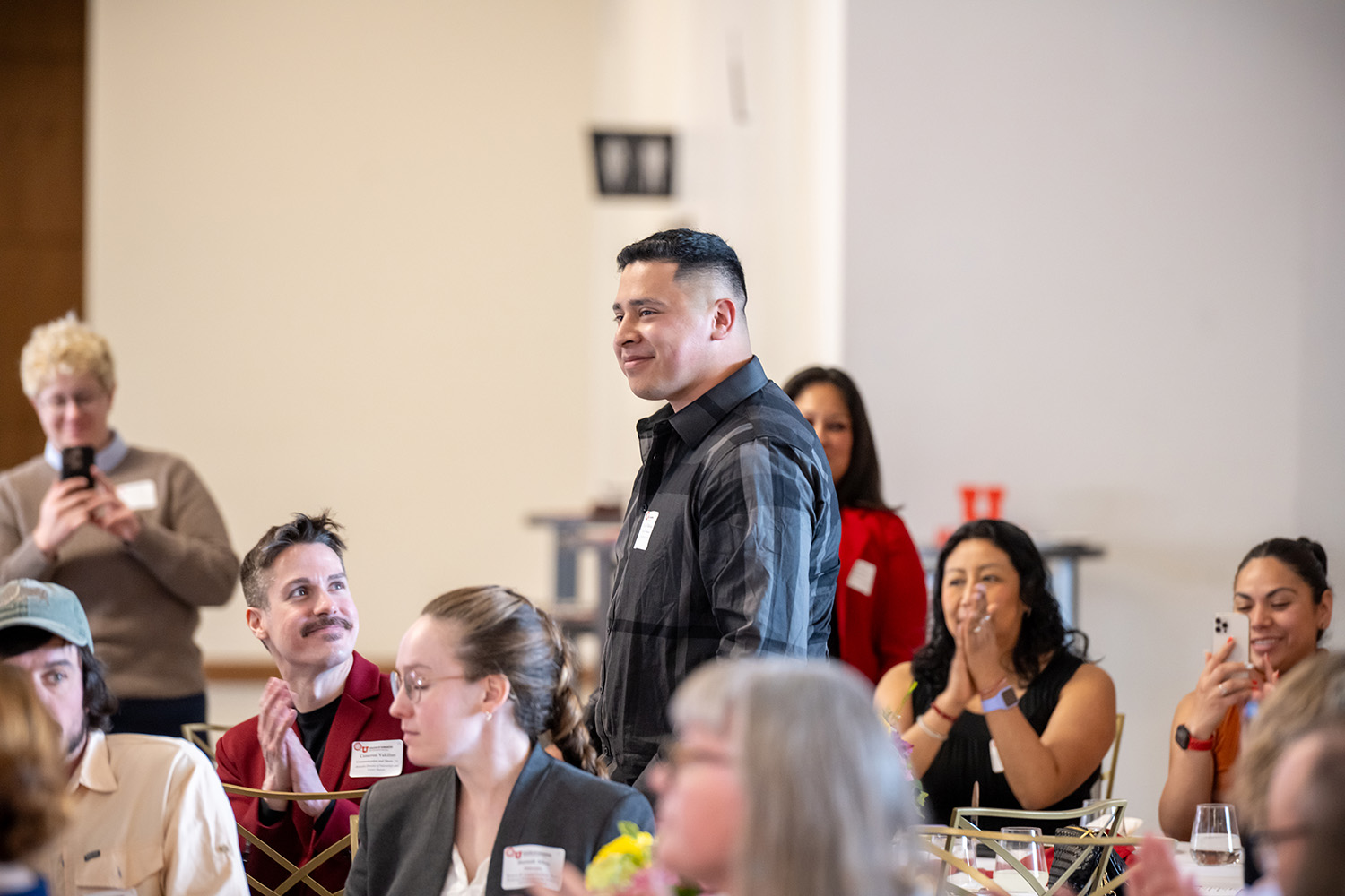 Guests at the Distinguished Alumni Luncheon acknowledge student award winner Tomas Cruz Villalvazo