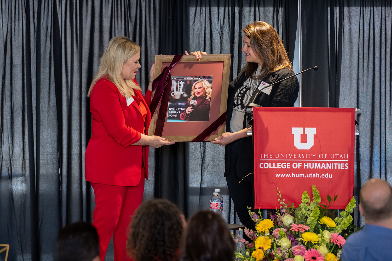Marcie presents Holly with a framed newspaper cover