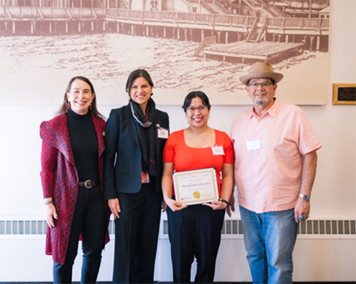 Marylinda holding plaque with mentors and Dean