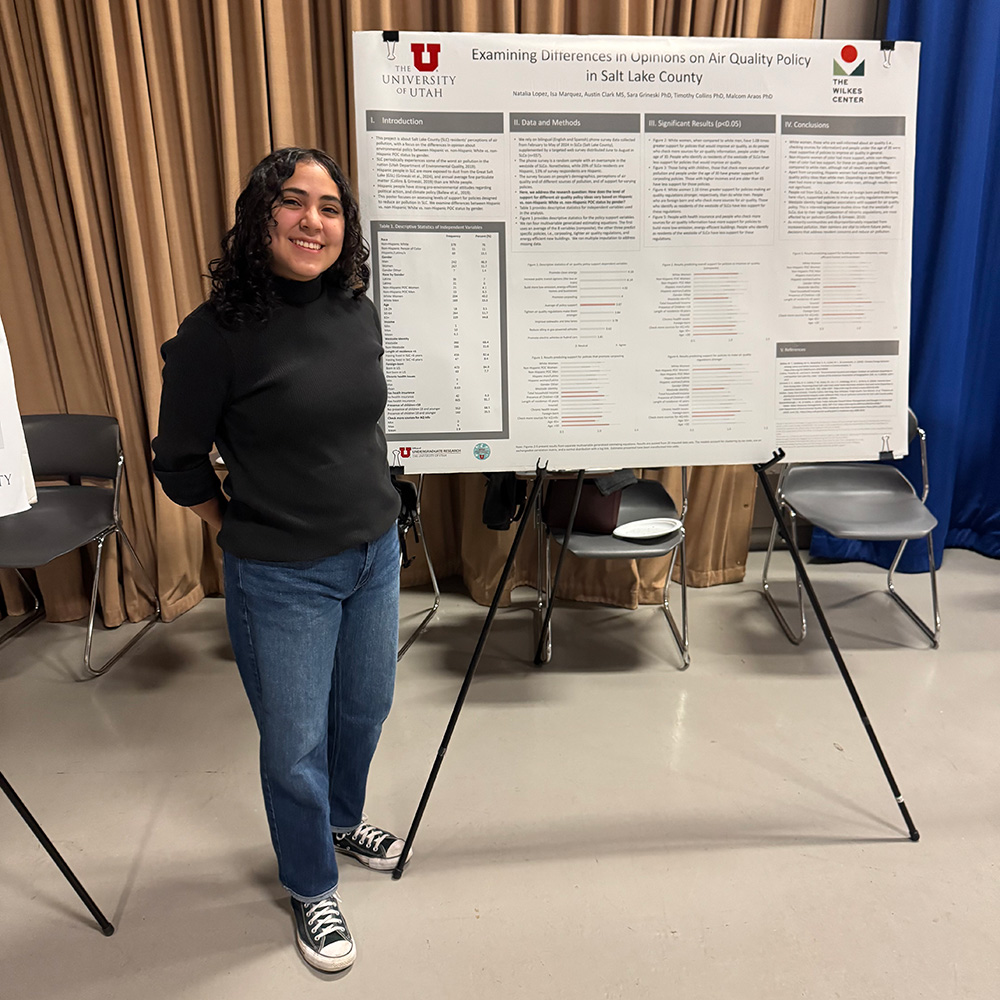 Natalia standing with her research poster