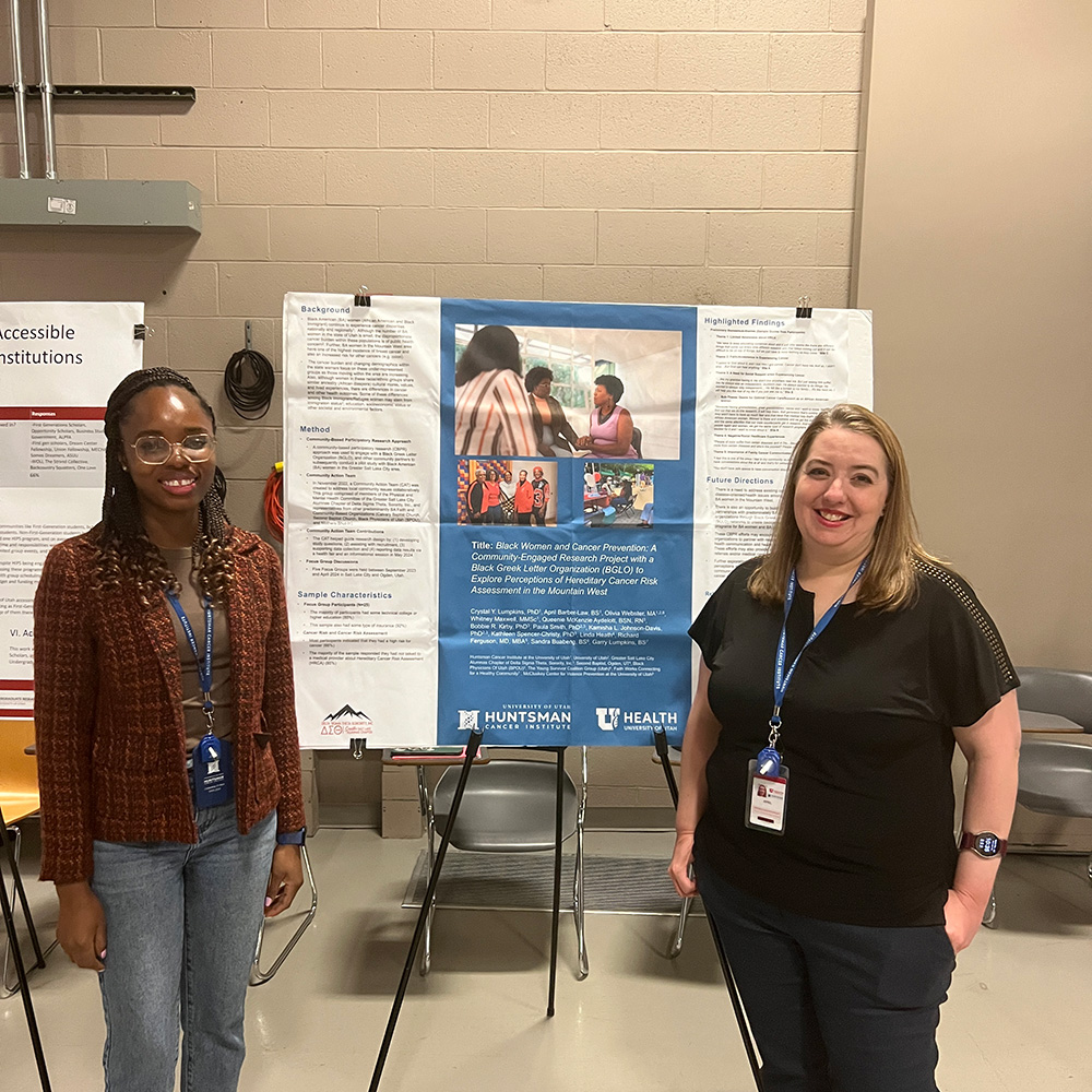Olamide and April standing with research poster