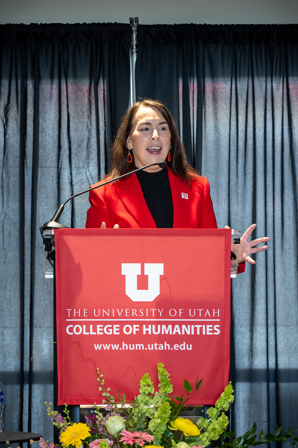 Wanda Pillow speaks from behind a podium draped with a College of Humanities banner