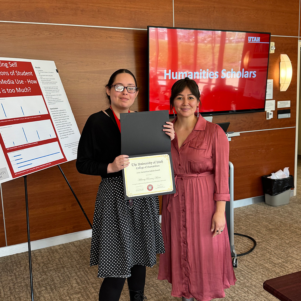 Lepa and Melaney standing togther and smiling at the camera. Melaney is holding a certificate.